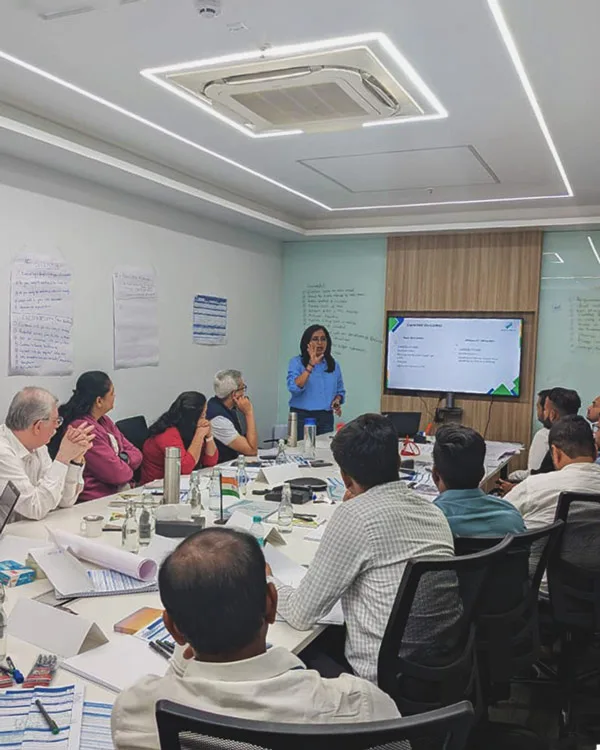 B2B Sales Training for Better Business Growth Professional corporate sales training workshop session with an facilitator presenting to a business team in a conference room.