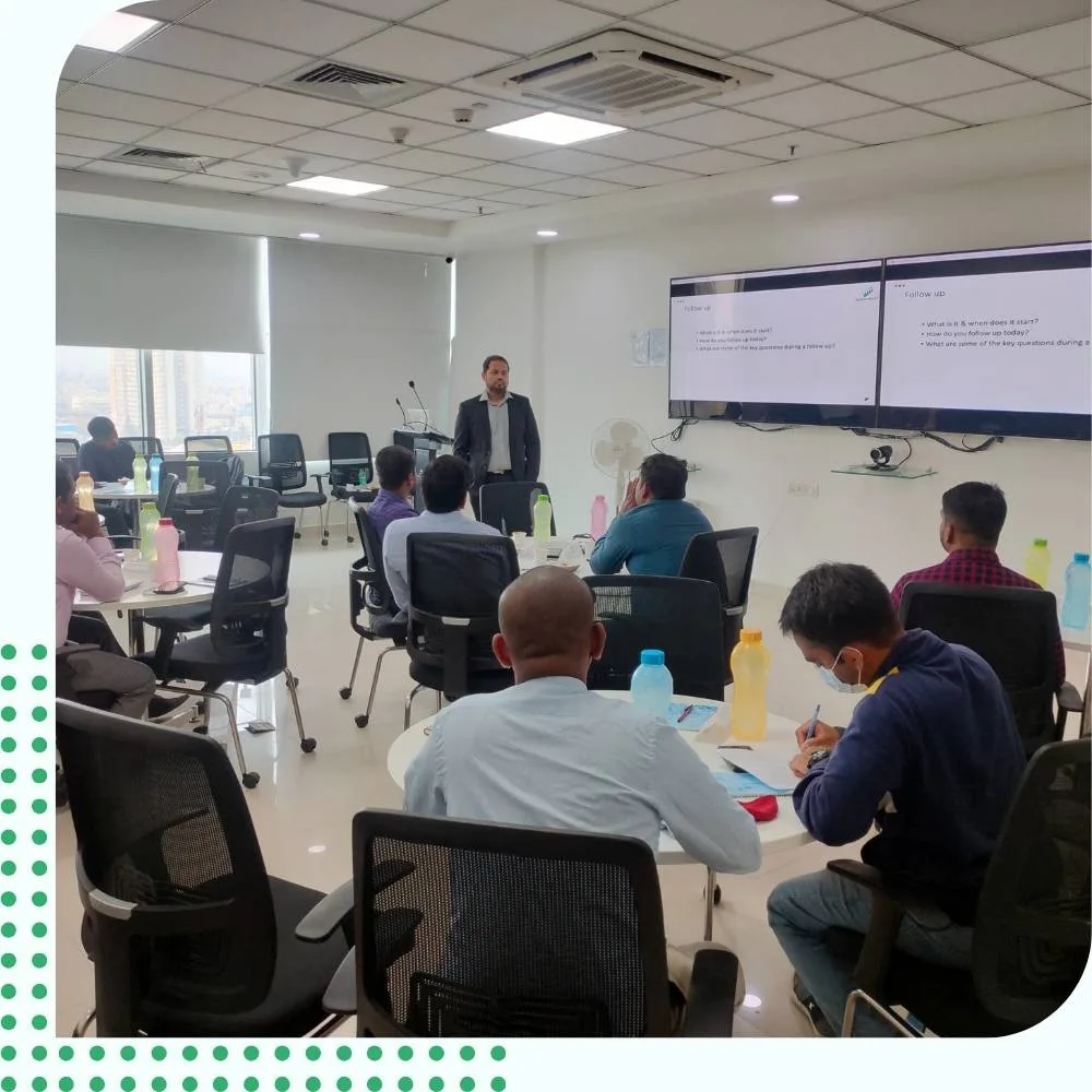 An expert sales trainer delivering an interactive IT sales training session to sales professionals.