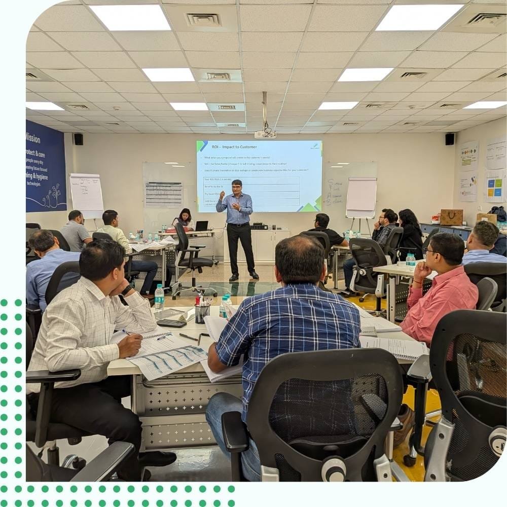 Live Corporate Sales Training Workshop and ROI Corporate instructor presenting business metrics on a sales training workshop to enterprise managers