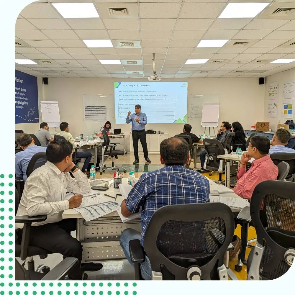 Live Corporate Sales Training Workshop and ROI Corporate instructor presenting business metrics on a sales training workshop to enterprise managers